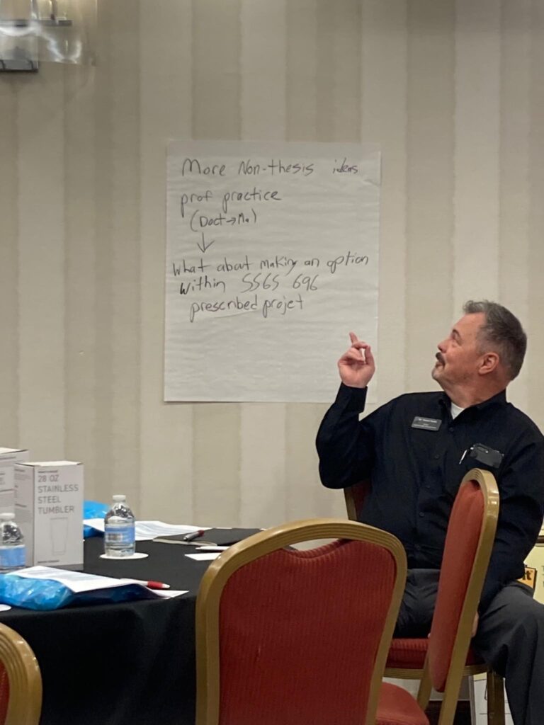 Dr. Smith leading a meeting, pointing at a paper 